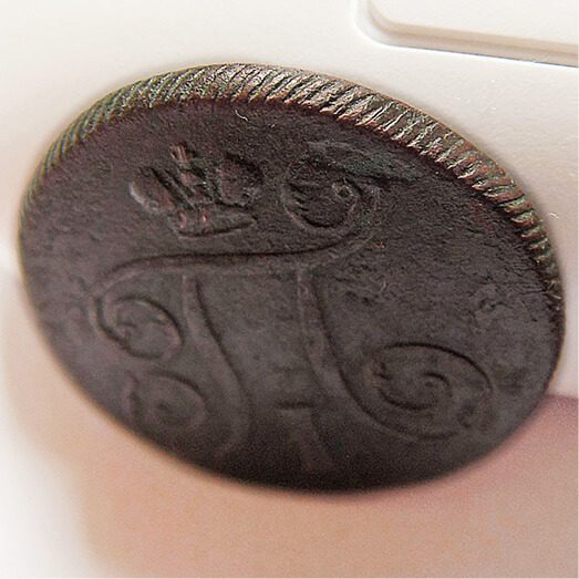 An old coin with a crown on it.