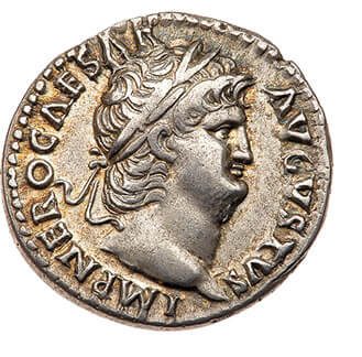 A silver coin minted with a man's head stamped on it.