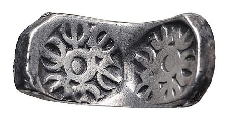 A silver coin with a flower design on it, showcasing the rich history of coins.