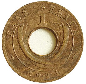 A brown with a hole in it, displaying a mint mark.