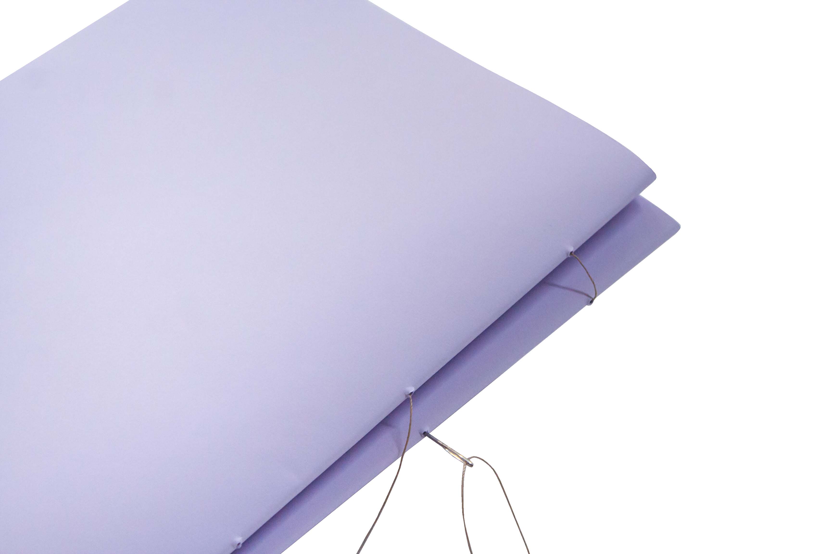Purple yoga mat partially rolled against a white background.
