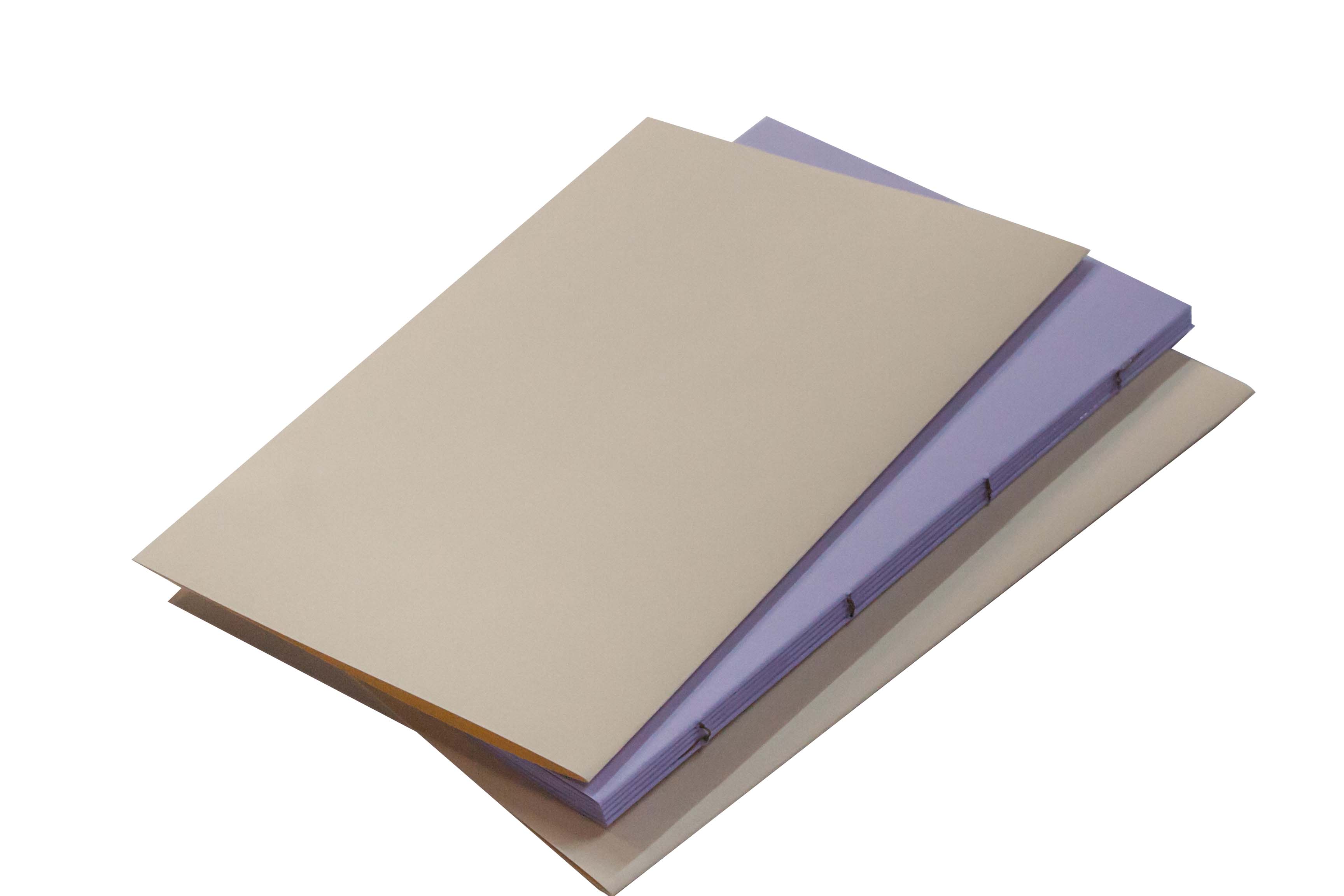 Bookbinding. Two hardcover books stacked on top of each other with the top book slightly askew.